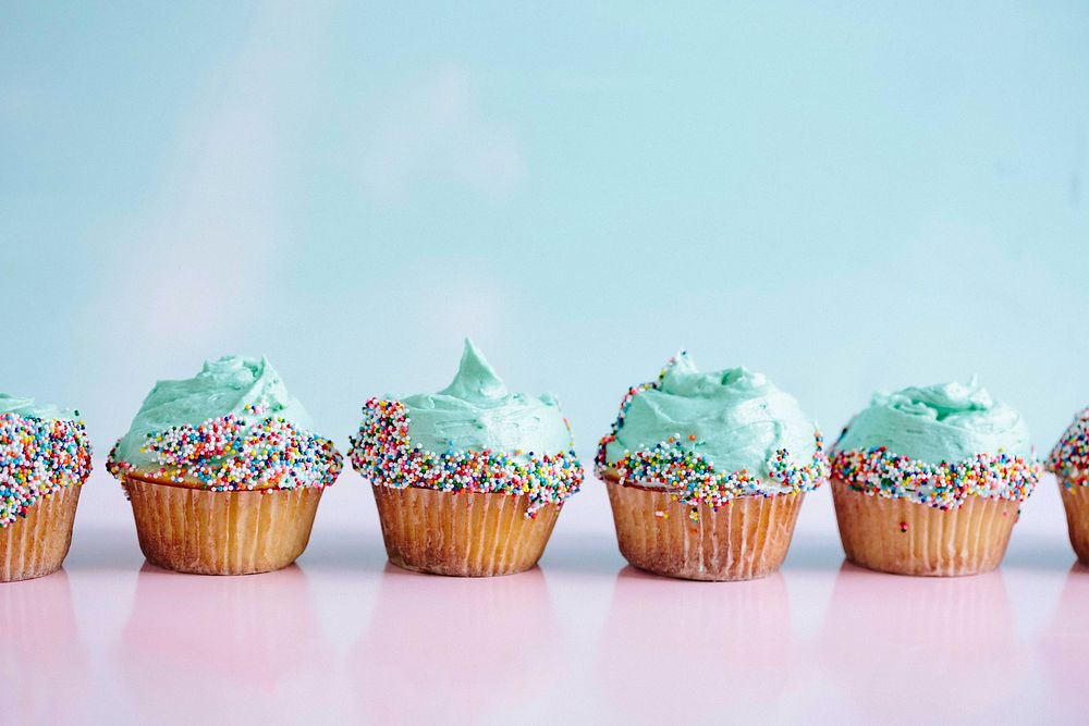 Blue frosting cupcakes and rainbow sprinkles. Original public domain image from Wikimedia Commons