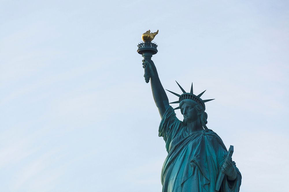 The Statue of Liberty in New York City with the blue sky behind her. Original public domain image from Wikimedia Commons