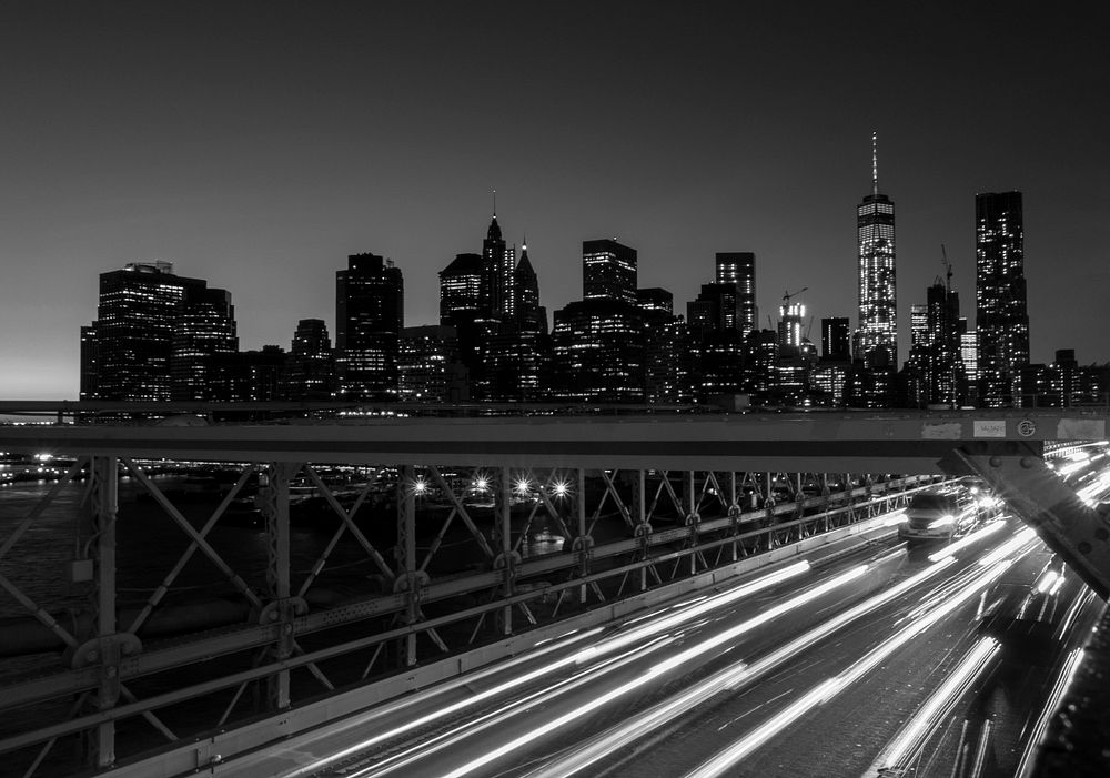 Black and white long exposure view at night over the Brooklyn Bridge. Original public domain image from Wikimedia Commons