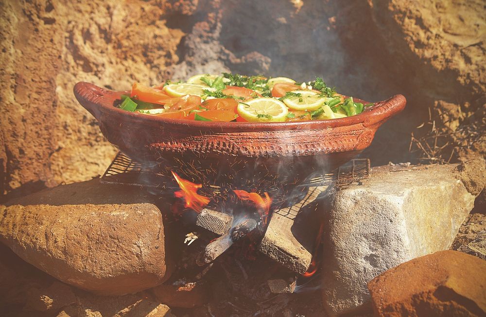 Moroccan dish with lemons and vegetables cooking over hot coals. Original public domain image from Wikimedia Commons