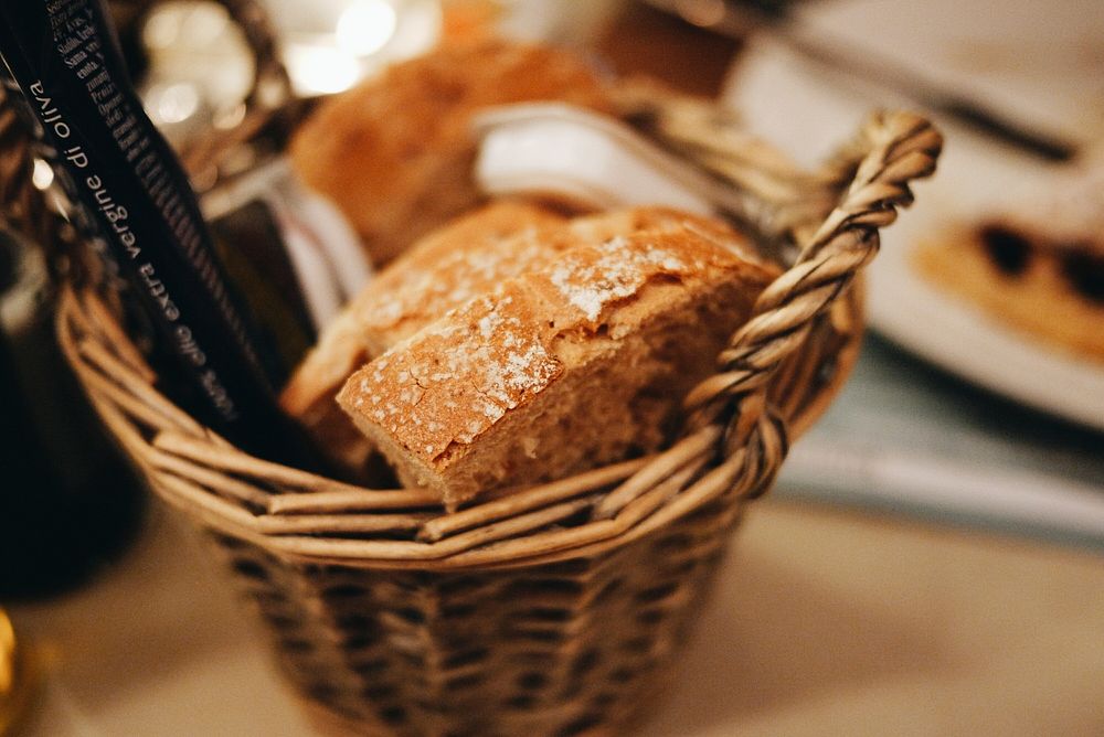 Basket of bread on a table at a restaurant. Original public domain image from Wikimedia Commons