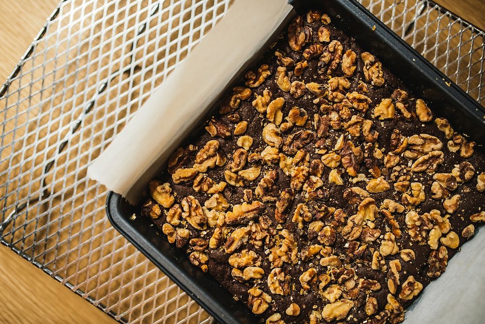 Chocolate brownie dessert with walnuts cooling on a rack. Original public domain image from Wikimedia Commons