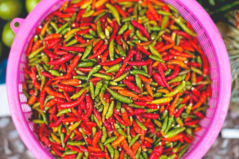 Pink bowl of spicy chili peppers at a street market. Original public domain image from Wikimedia Commons