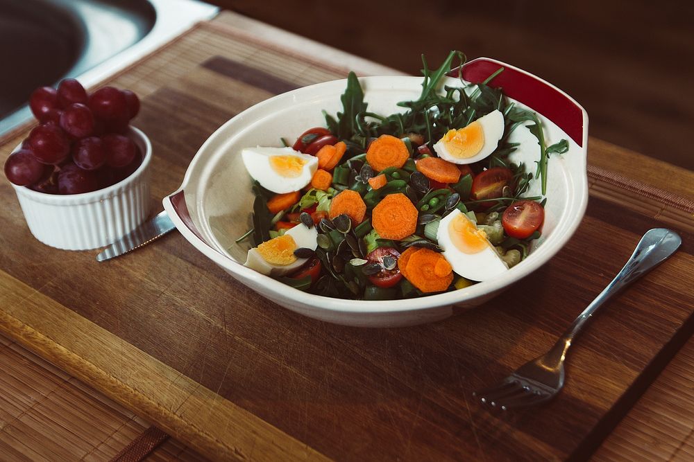 Healthy salad with egg, kale, carrots, and roasted veggies. Original public domain image from Wikimedia Commons