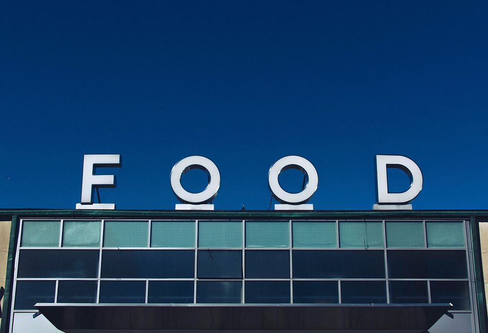 White "FOOD" sign outside a grocery store. Original public domain image from Wikimedia Commons