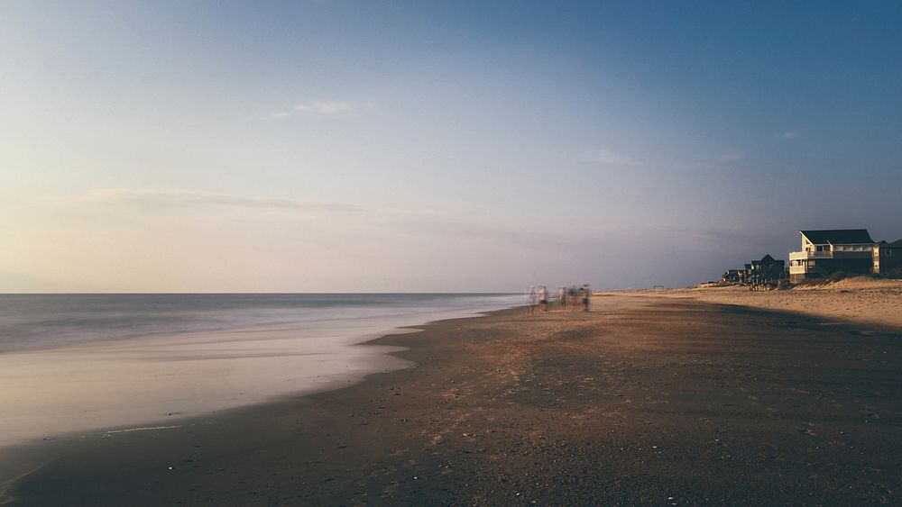 Blurry landscape capture of people doing early during sunrise at a beach in Rodanthe Pier. Original public domain image from…