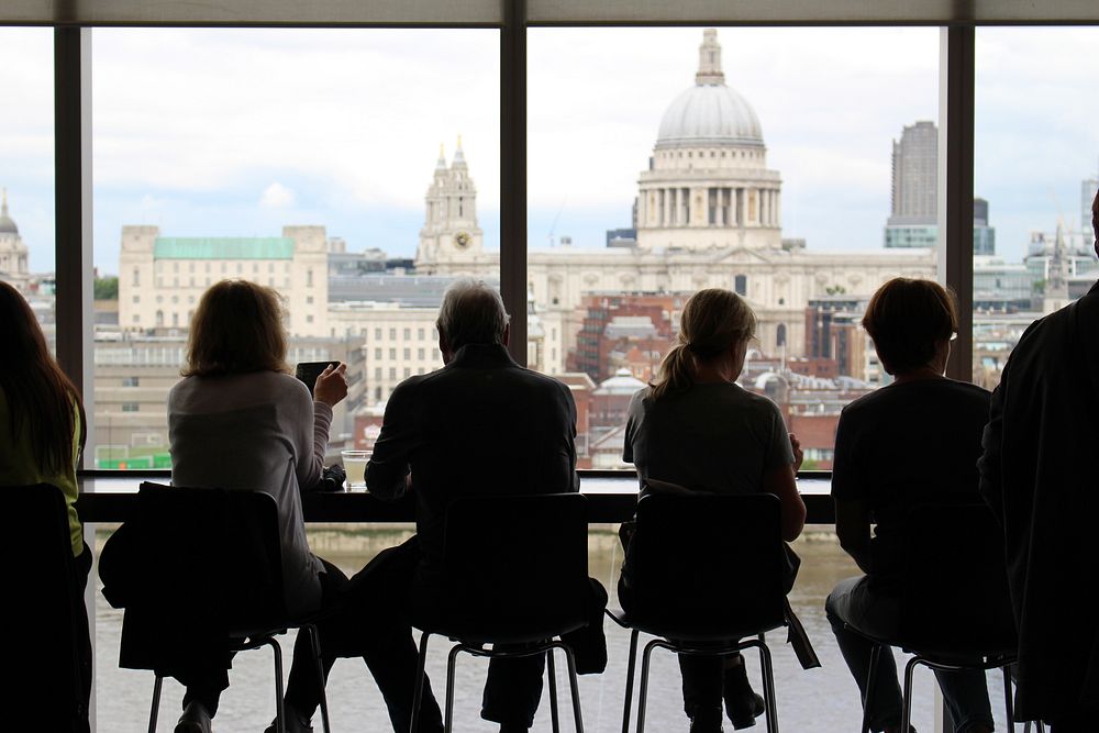 People sitting at a table at a café with a view on St. Paul's Cathedral in London. Original public domain image from…