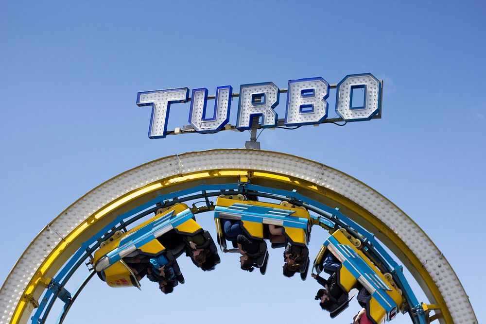 People upside down on a rollercoaster in an amusement park. Original public domain image from Wikimedia Commons