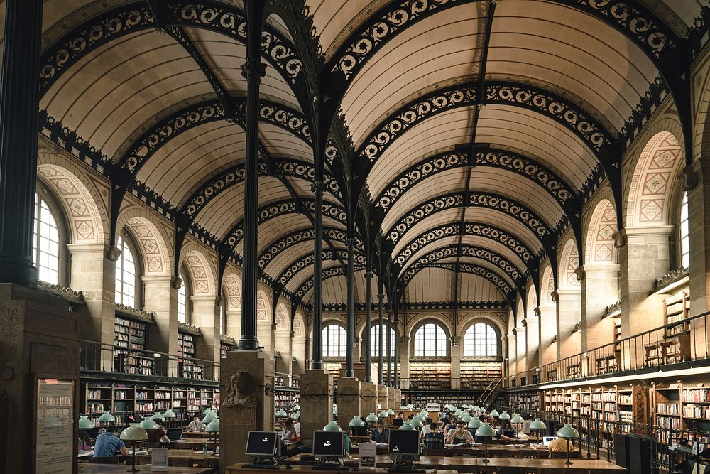 Beautiful library with arches and bookshelves in Paris. Original public domain image from Wikimedia Commons