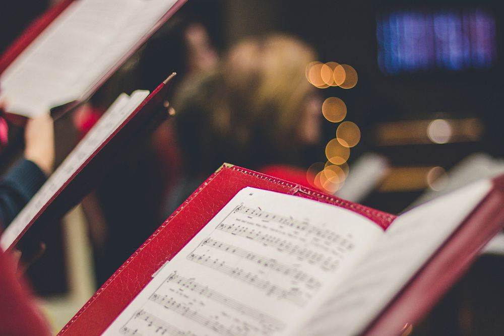 A close-up of a music score in a red leather case with bokeh effect in the background. Original public domain image from…