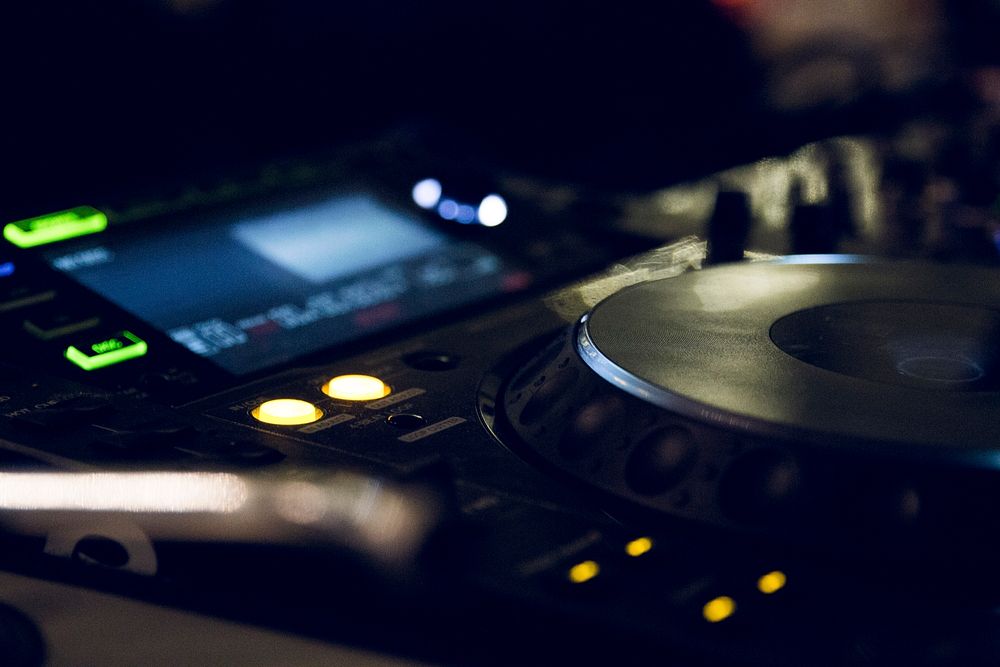 A close-up of a DJ's turntable with shining lights. Original public domain image from Wikimedia Commons