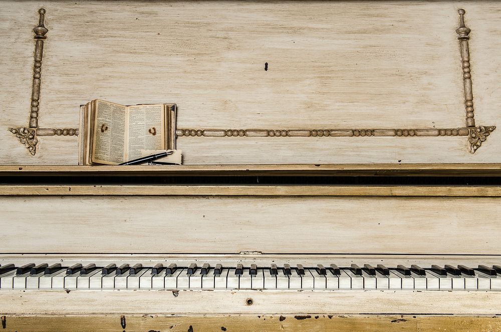 Old vintage piano with an open book on it. Original public domain image from Wikimedia Commons