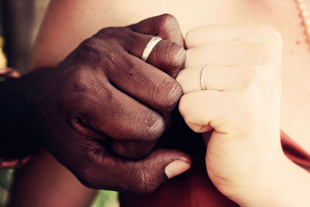 Two person showing rings. Original public domain image from Wikimedia Commons