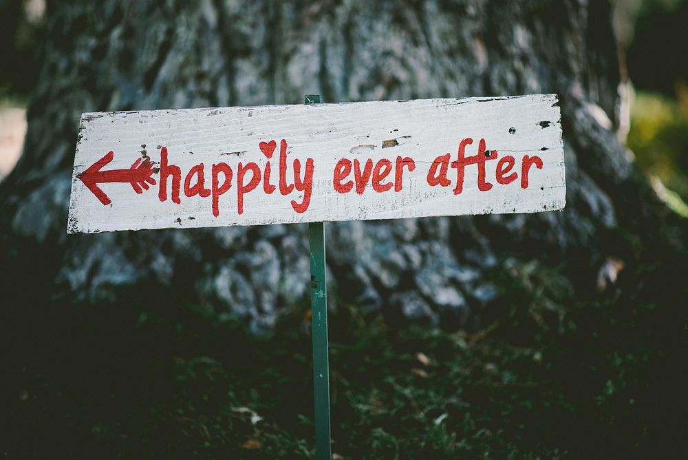 A hand-painted sign reads "Happily ever after". Original public domain image from Wikimedia Commons