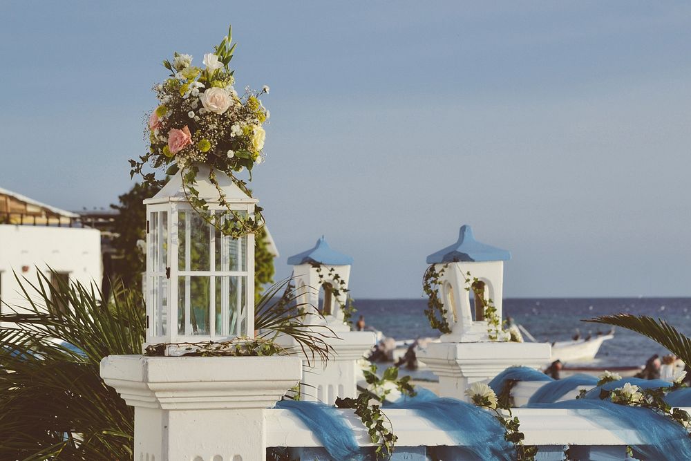 A bunch of flowers on top of a balustrade in a Mediterranean setting with the sea in the background. Original public domain…