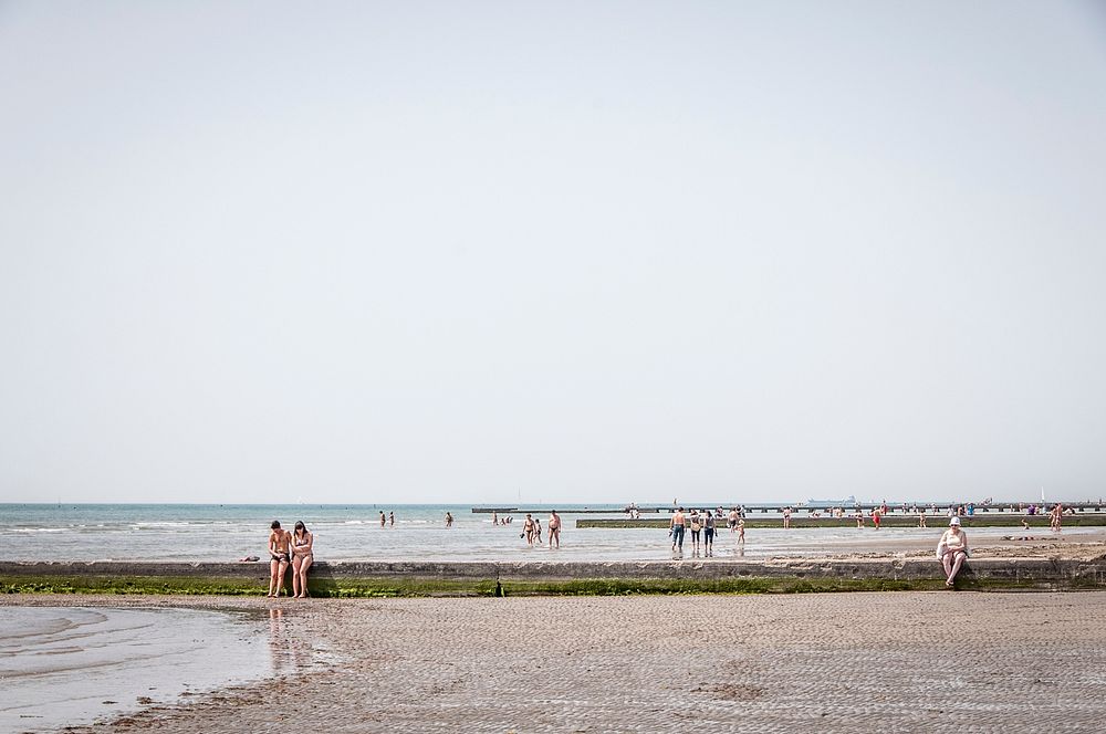 Happy people and couple enjoying time on beach in Grado Italy. Original public domain image from Wikimedia Commons