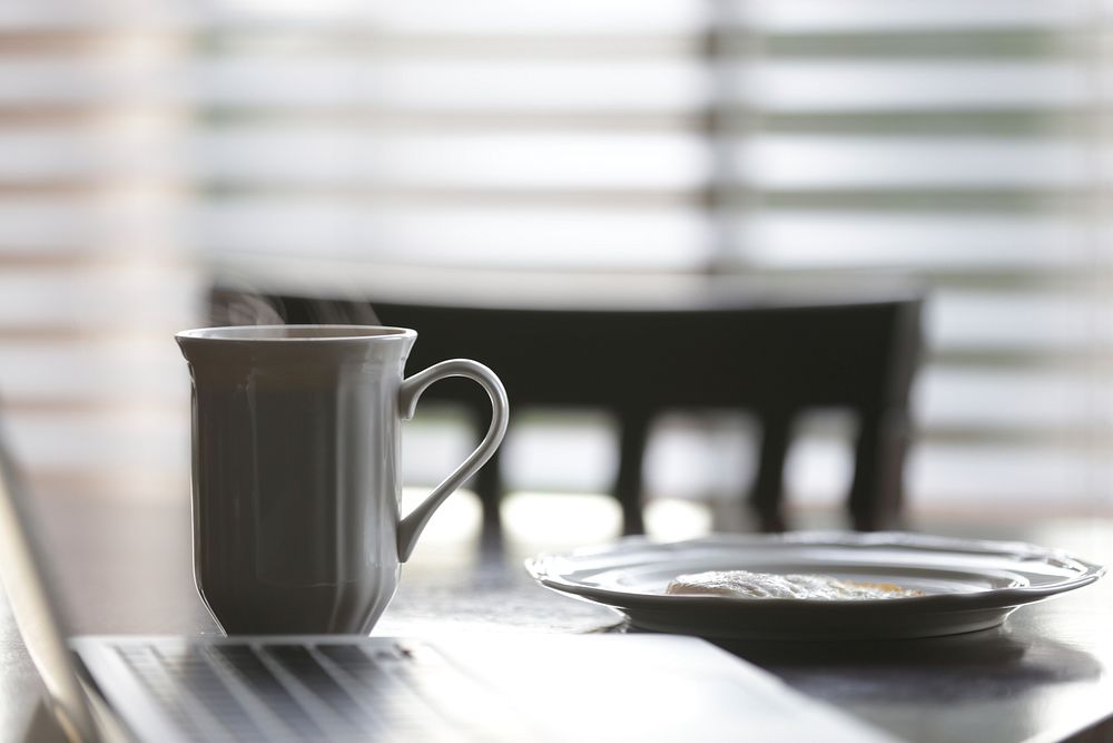 White ceramic mug beside plate on table. Original public domain image from Wikimedia Commons