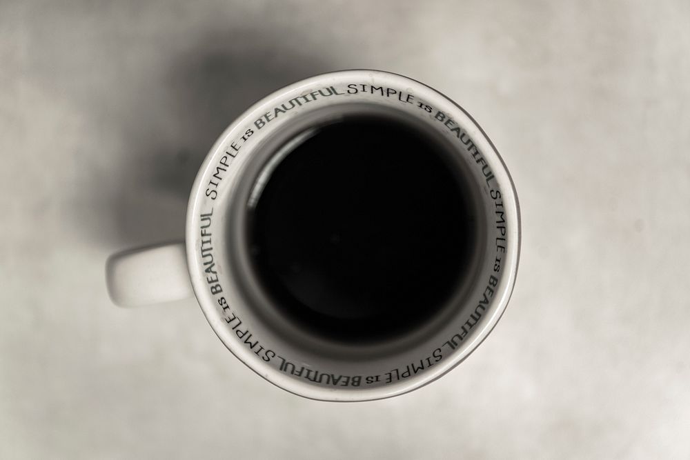 Black coffee in white simple is beautiful cup on white table from above, Chicago. Original public domain image from…