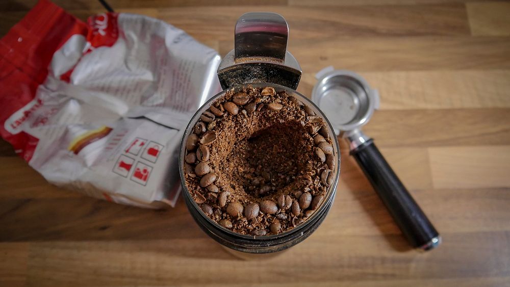 Coffee grinder full of beans and grounds. Original public domain image from Wikimedia Commons