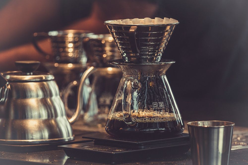 A jar with drip brewed coffee on a counter. Original public domain image from Wikimedia Commons