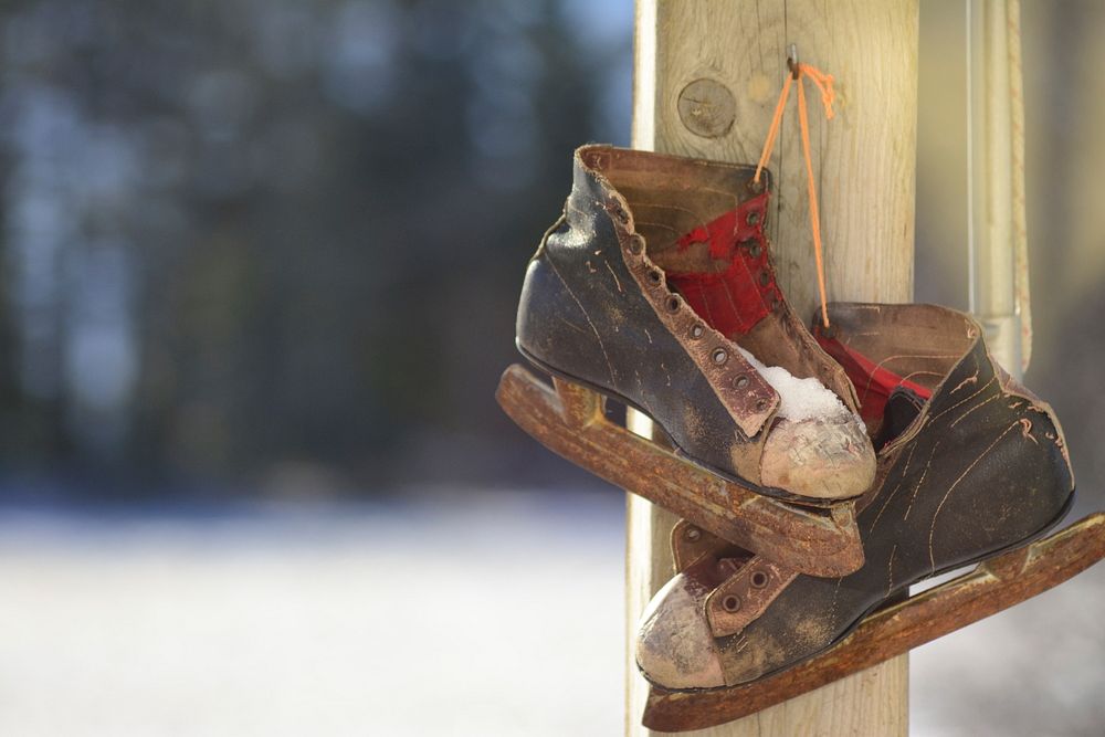 An old small sized ice skating shoe with wooden skates under it in Whitney.. Original public domain image from Wikimedia…