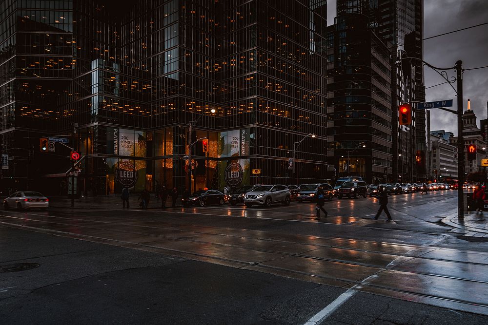 Silhouettes of pedestrians crossing a wet street in Toronto. Original public domain image from Wikimedia Commons