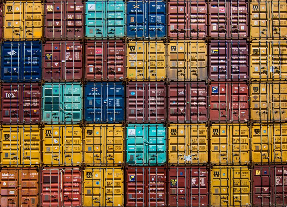 A stack of shipping containers forming a colorful pattern. Original public domain image from Wikimedia Commons