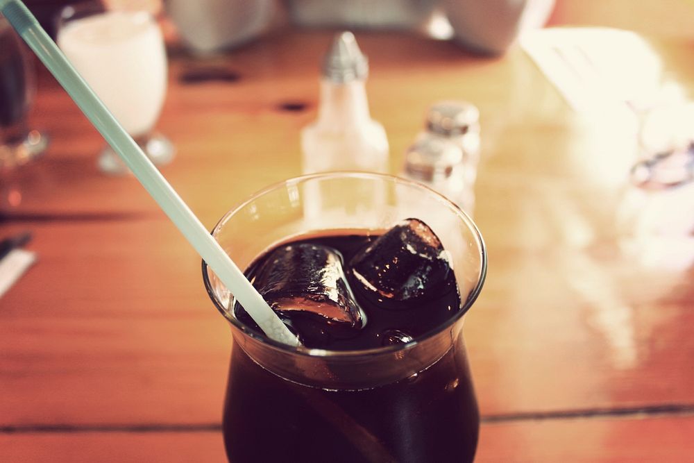 Refreshing glass of soda with ice and a straw at a diner. Original public domain image from Wikimedia Commons