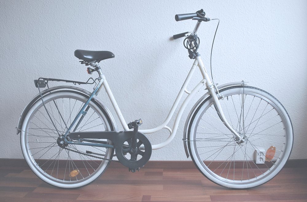 A white bicycle with a lock. Original public domain image from Wikimedia Commons
