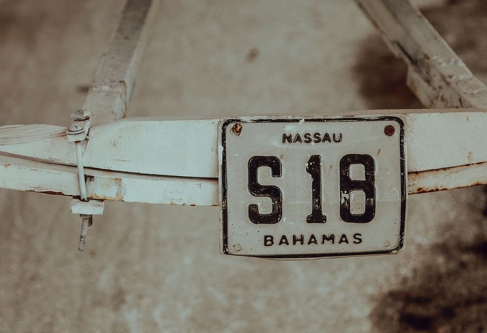 A vintage license plate of an old white Bahama bike in Nassau.. Original public domain image from Wikimedia Commons