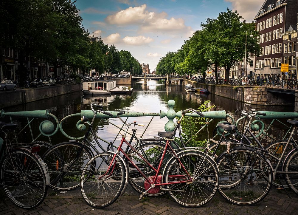 Bicycle parking in front of canal in Amsterdam. Original public domain image from Wikimedia Commons