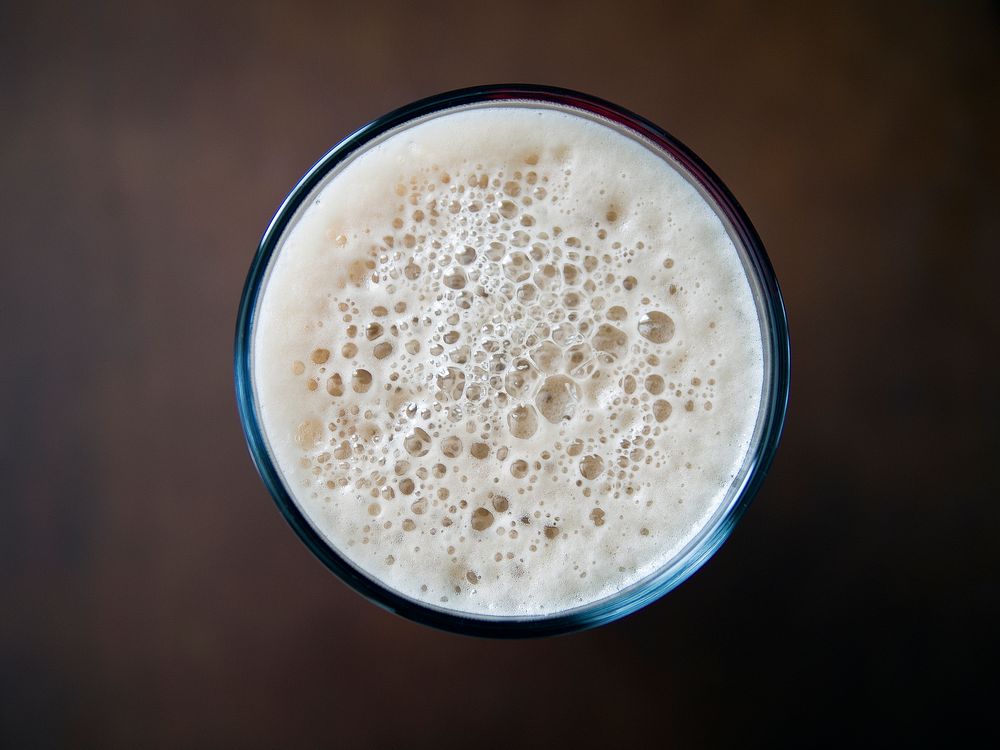 Macro view of the top of a drink with foam in a glass, British Columbia. Original public domain image from Wikimedia Commons