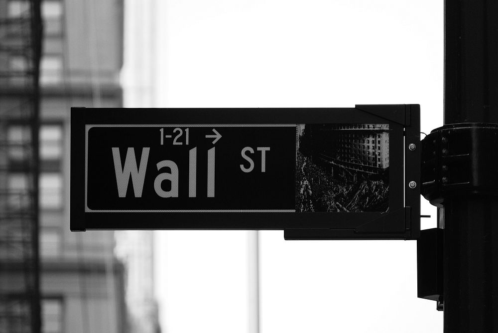Black and white photo of the street sign for Wall St in New York City. Original public domain image from Wikimedia Commons