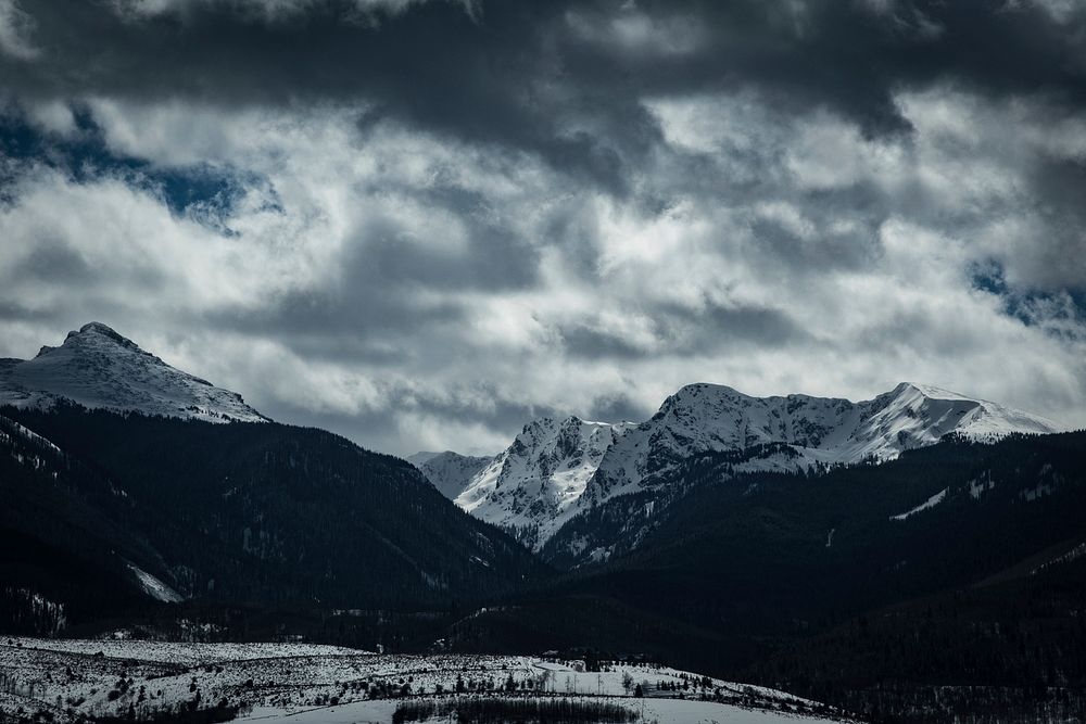 Cloudy sky over snow-capped mountains. Original public domain image from Wikimedia Commons