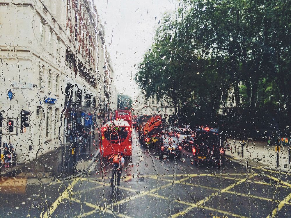 A busy London street seen through a rain-streaked window. Original public domain image from Wikimedia Commons