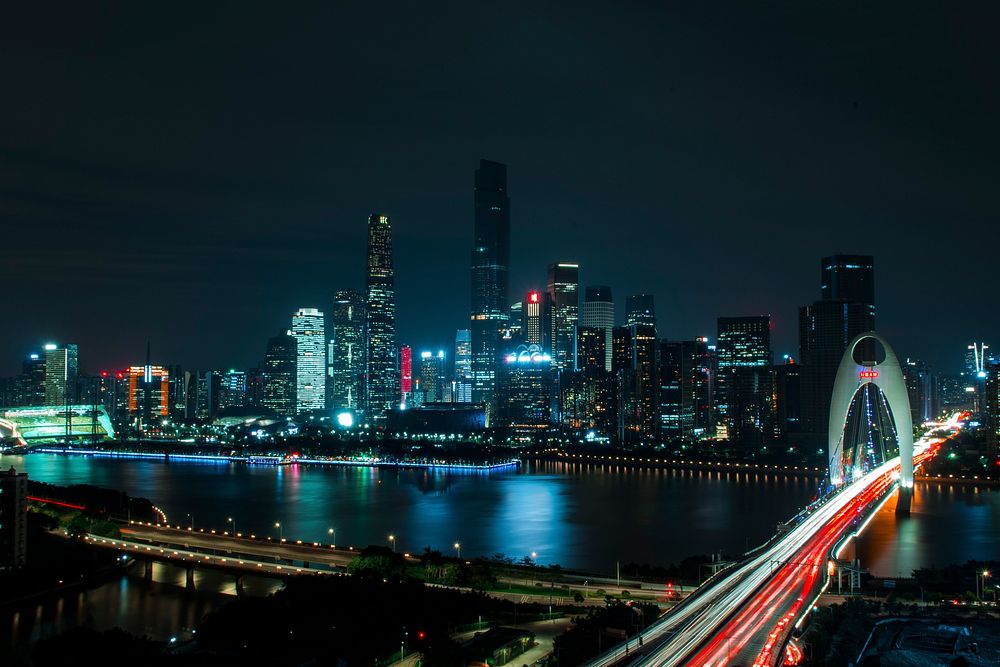 Downtown skyscrapers lit up on a busy night in the city. Original public domain image from Wikimedia Commons