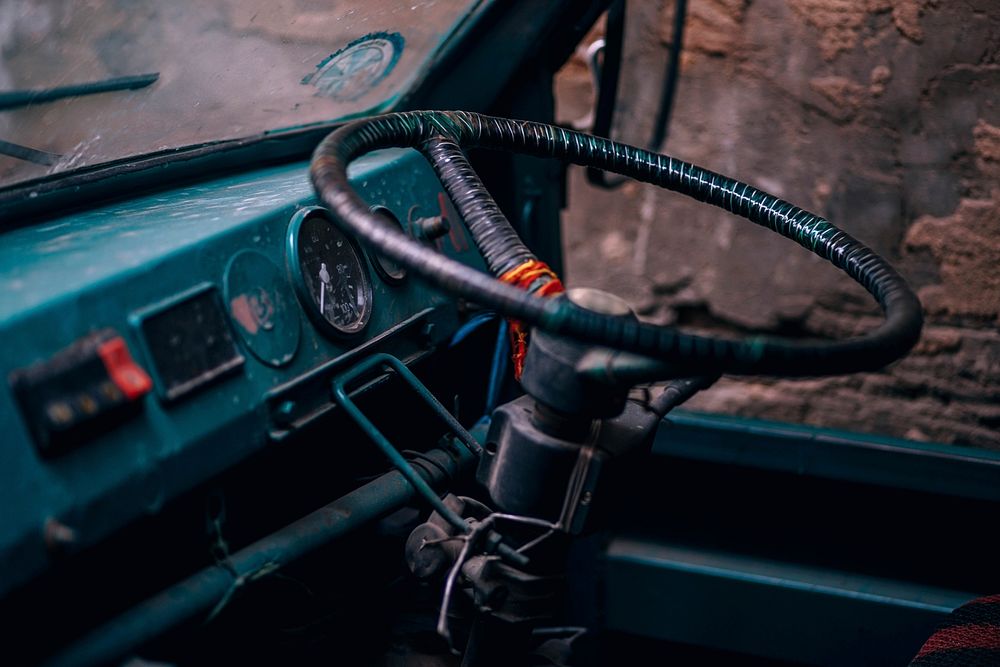 Blue dashboard and steering wheel of a classic car. Original public domain image from Wikimedia Commons
