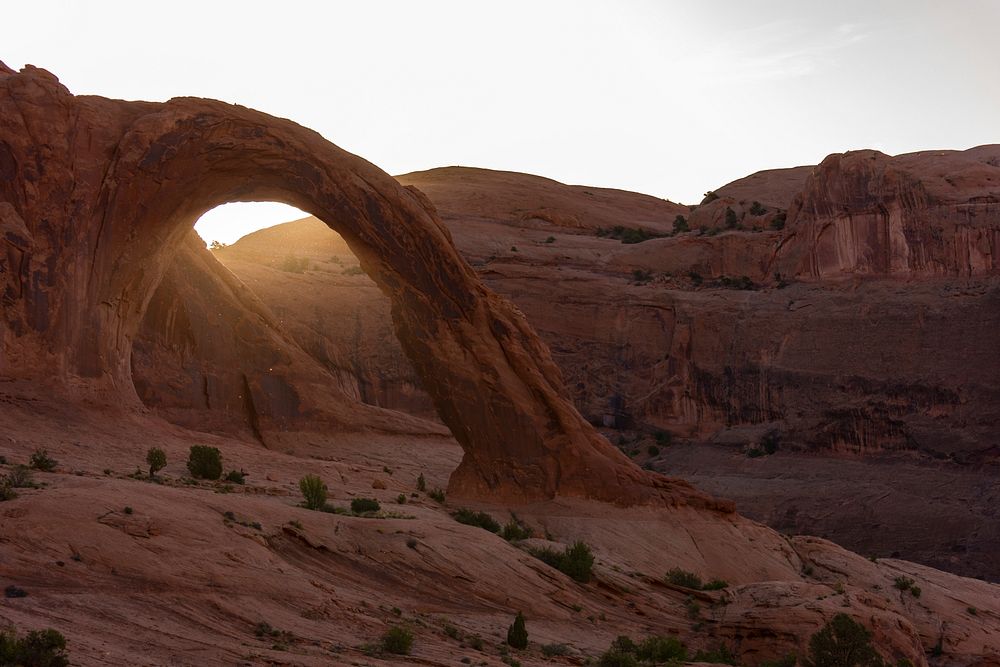 Sandstone forms natural archways in the desert of Corona Arch. Original public domain image from Wikimedia Commons