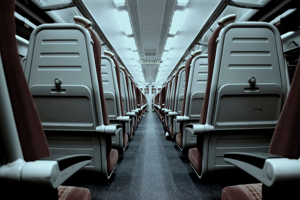 View from the back of the aisle in an empty train. Original public domain image from Wikimedia Commons