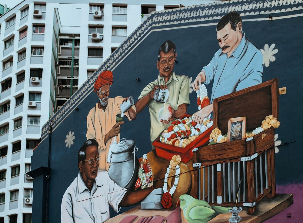 Graffiti mural of four men performing cultural ritual on urban building wall in Singapore-17 March 2017. Original public…