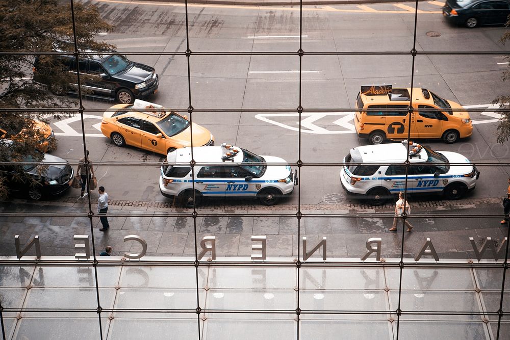A view of vehicles out on the road from insde a building's window.. Original public domain image from Wikimedia Commons
