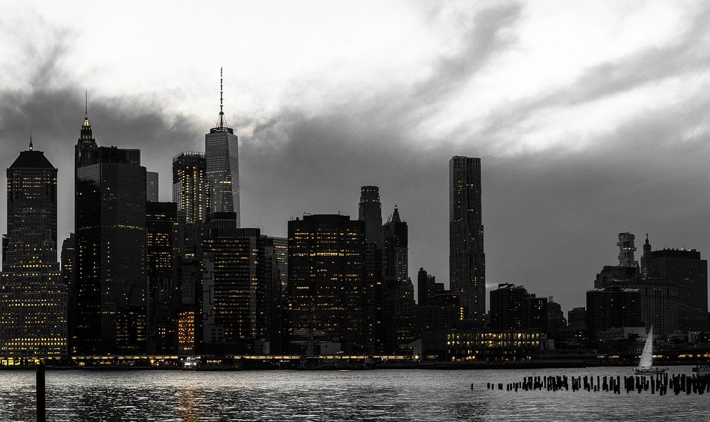 Dark view of a cloudy New York City from the river.Original public domain image from Wikimedia Commons