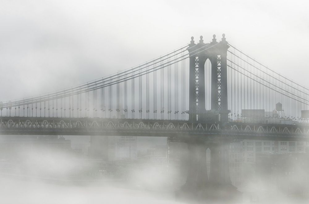 Brooklyn Bridge covered in mist on a foggy morning. Original public domain image from Wikimedia Commons