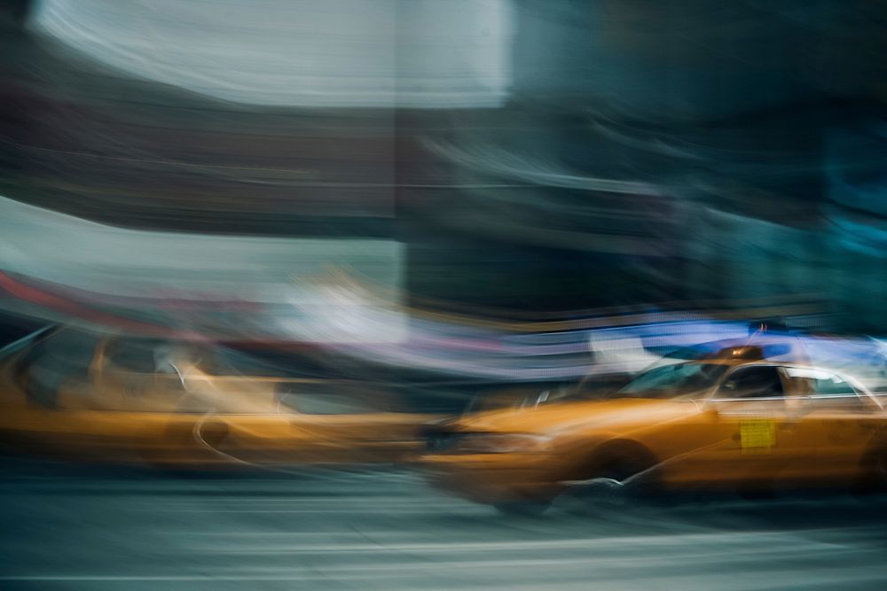 A blurry shot of a yellow taxi cab in New York City. Original public domain image from Wikimedia Commons