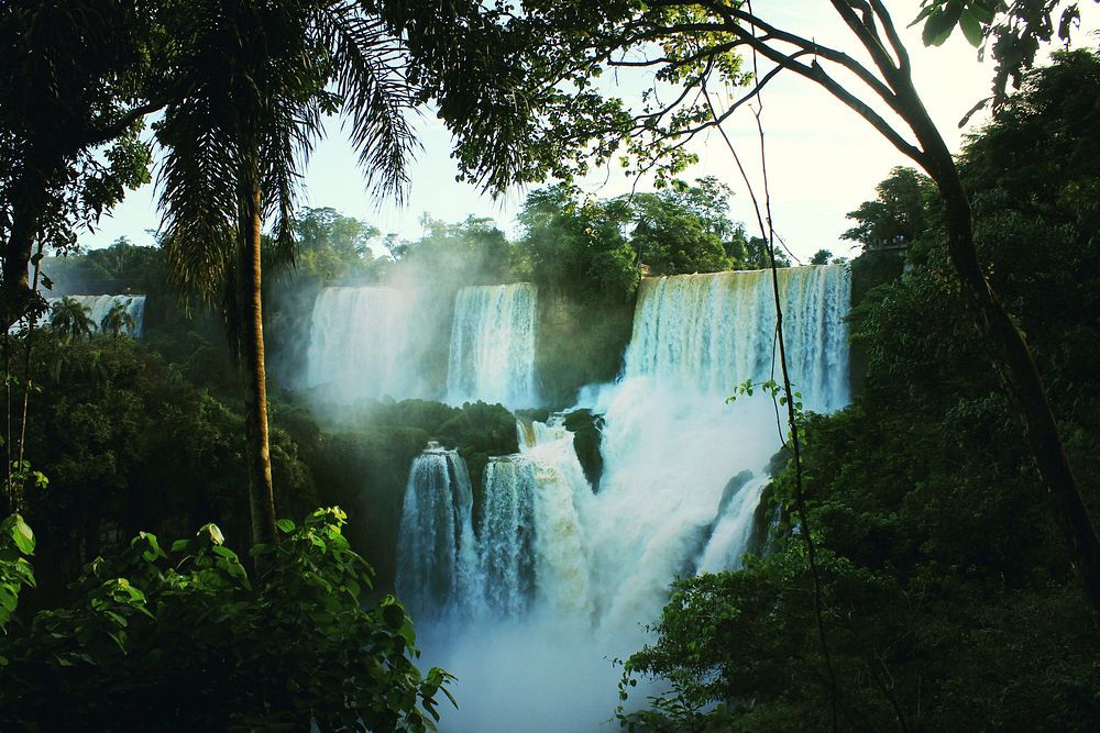 Several waterfalls cascading down in a tropical forest. Original public domain image from Wikimedia Commons