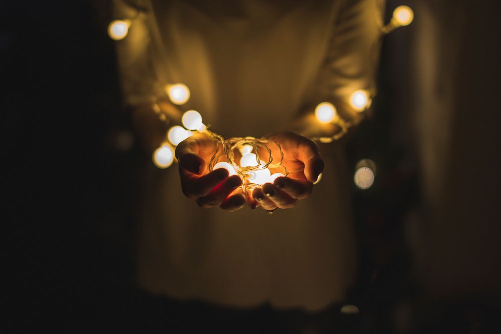 Person holding fairy lights. Original public domain image from Wikimedia Commons