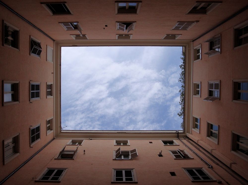 Scattered clouds in the sky framed by the well of an apartment building in Rome. Original public domain image from Wikimedia…