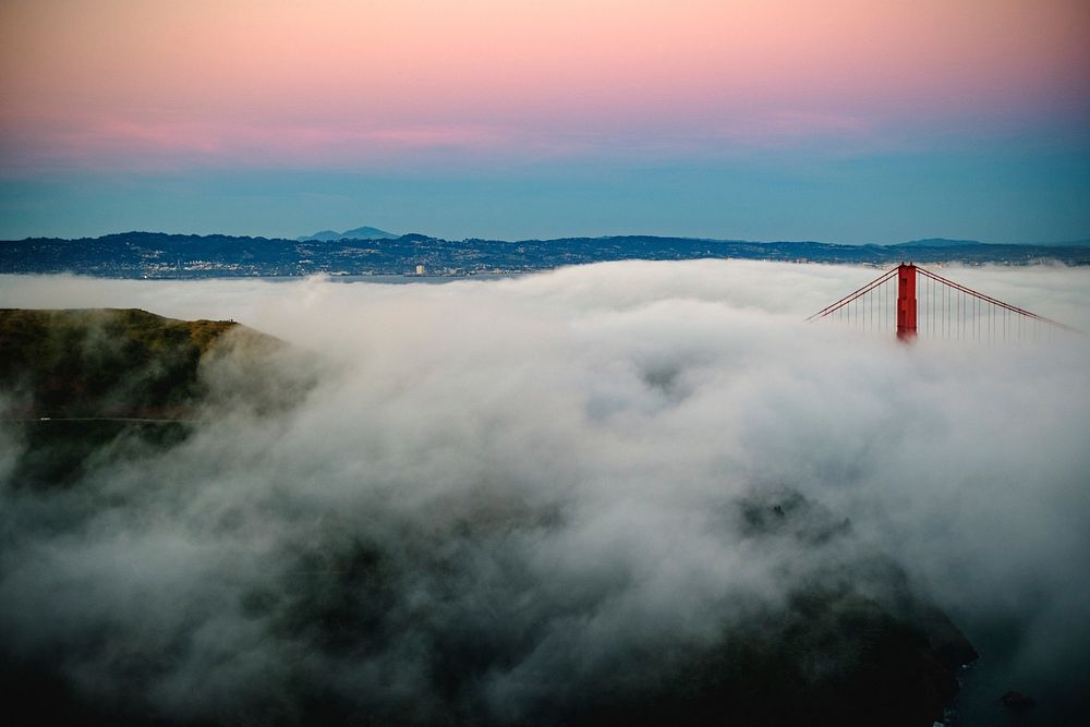 Densely foggy sunrise showing the top of Golden Gate Bridge from Marin Headlands. Original public domain image from…