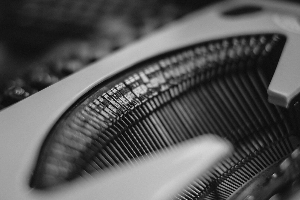 Typebars inside a typewriter in black and white. Original public domain image from Wikimedia Commons