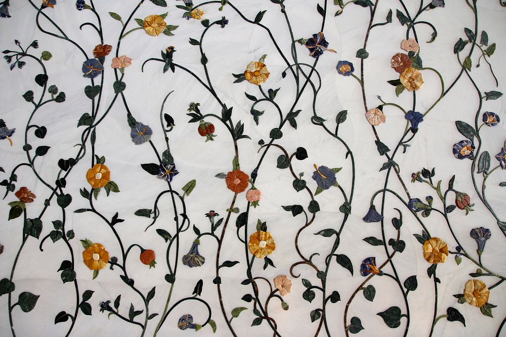 Paper flower decorations on a white wall. Original public domain image from Wikimedia Commons